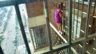 Chinese girl, 5, rescued after she got her head stuck in bars OUTSIDE of apartment's 24th floor.