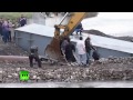 Crazy ferry video: Russians cross river in backhoes