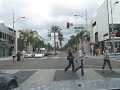 Driving through Rodeo Drive Beverly Hills Los Angeles (cars, houses and shops)