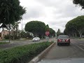 Driving through Rodeo Drive Beverly Hills Los Angeles (cars, houses and shops)