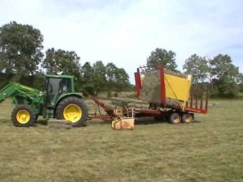 loading small square bale hay with 1033 balewagon newholland - YouTube