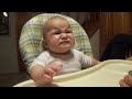 Baby makes funny faces while eating apples