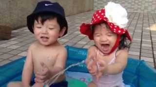 Twins playing in the baby pool