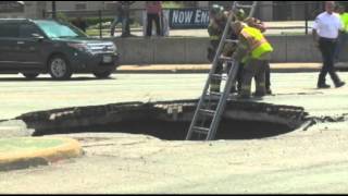 Raw: Woman Rescued After Driving Into Sinkhole