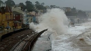 Dramatic scenes as huge waves batter Dawlish sea wall and station.Beach huts smashed.