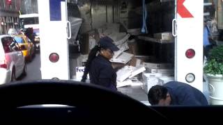 FedEx employee throwing items in truck