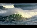 Kelly Slater and Joel Parkinson surfing big waves in Praia do Norte Nazare