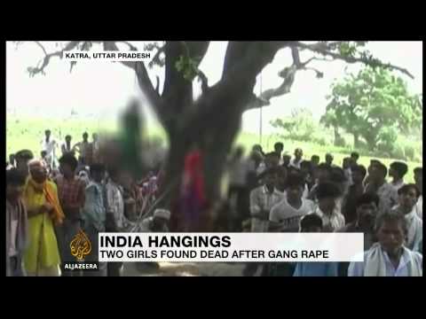 Police say two teenage sisters found dead in rural India were raped and strangled before being hanged.
Subscribe to our channel  http://bit.ly/AJSubscribe
Follow us on Twitter https://twitter.com/AJEnglish
Find us on Facebook https://www.facebook.com/aljazeera
Check our website:  http://www.aljazeera.com/

  The girls\' bodies were found hanging from a tree in the village of Katra in Uttar Pradesh on Wednesday.  Autopsies have confirmed they were gang-raped.  Four men have been arrested, and police are searching for three more.  Authorities say the suspects include at least two police officers.