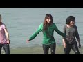 Burmese  Chinese girls playing with water at Ngapali beach.m2ts