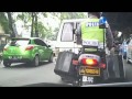 2 Indonesian police motorcycles escorting a convoy of cars - 1