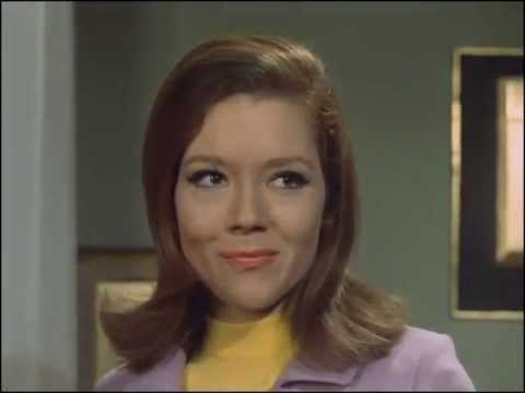 Youtube video - Mrs. Peel wakes from a nap to find a toy carousel on her table. One of the knights bears a flag that reads ‘Mrs. PEEL’. Steed appears and says, ‘We’re needed!’