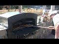 Wood pizza oven - Cooking pizza in an outdoor wood fired pizza oven