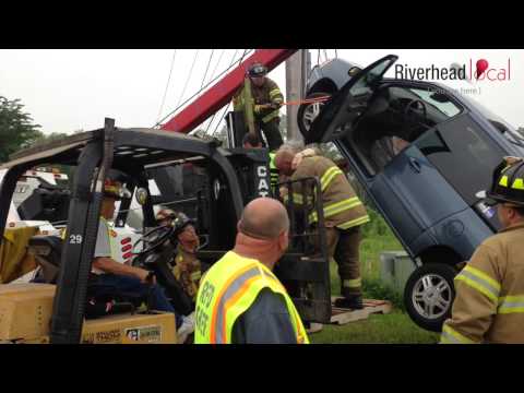 WATCH: Firefighters rescue elderly woman trapped in vehicle suspended on utility pole guy wire