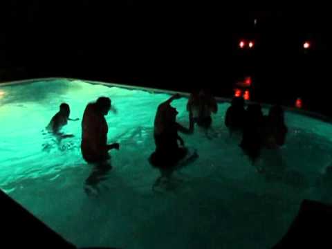 Wedding party jumps in the pool