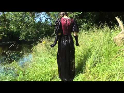 Girl in formal dress takes buckets of water then into the river in her dress