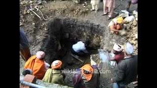 Dead body of a sadhu bleeds during the last rites