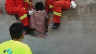 Firefighters save woman stuck between two walls in China