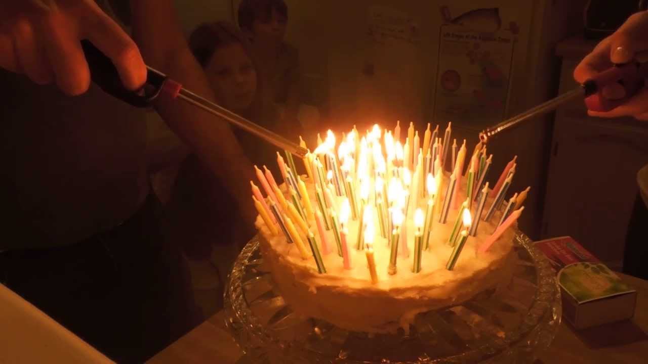 Lighting and blowing out 100 birthday candles - YouTube