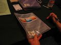 Howard Tayler sketches in a book at Dragon Con