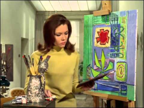 Youtube video - Mrs. peel is painting a modernist picture, she turns to refresh he brush and when she returns, she finds that Steed has signed the corner ‘Mrs. PEEL’; he smiles at her and says, ‘We’re needed’