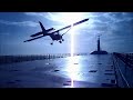 Extreme small plane landing on a ship at sea