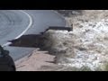 Raw footage from the front lines as a cameraman follows along with the Fire Department responing to some of the Extreme Flooding from the Big Thompson Canyon this evening between Loveland, CO and Estes Park, CO.

Land Lines and Cellular phone coverage is down and power is flashing in Estes Park, CO.

Travel is not advised, it just is impossible as Highway\'s 7, 34, and 36 are gone because they are just washed out.

Clip 1: Water over flowing the Damn Store at the mouth of the Big Thompson and over topping the control gate.

Long clip that shows massive flooding and workers opening more flood gates.

Clip 2: Shot of flooding sign with flooding in the background with the sign saying you are entering Big Thompson Canyon.

Clip 3: Park flooding. Footage from above the park.

Clip 4: Driving along the river in the Big Thompson Canyon.

Clip 5: Driving along the road as part of the bank is eroding. Extreme flooding in the river next to the road and then a waterfall on the side of the road on the right side.

Clip 6: POV driving shot through high water while following fire crews they were documenting.

Clip 7: Crews setting up for a rescue. Long clip that shows extreme flooding and a car that almost went into the water with skid tracks that go to the edge.

Clip 8: Shows a home getting blasted by ragging flood water. Camera pans back to the fire crews setting up with a hook and ladder truck to rescue people on the other side of the river.

Clip 9: Water blasting the side of the roadway as it undercuts the road and you can see chunks of the road fall away into the water.

Clip pans to the across the river from on top of the fire truck as crews rig up to bring more people back to safety.

Clip 10 More raging flood water and now shows the road is gone due to the flooding.

Clip 11: Further down the road that shows more raging flood water under cutting the roadway.

© StormChasingVideo.com