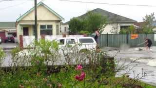 Couple of dudes wakeboarding in flooded street