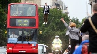 Magician Dynamo levitates on side of London bus