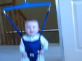 Funny baby laughing in jolly jumper