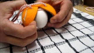 Scrambling an egg inside the shell with a tennis ball and string