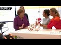 Merkel gets goofy while toying with robot at German Chancellery