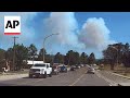 Residents flee New Mexico village as wildfires bear down on homes