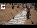 Palestinians bury the bodies of 54 people that Israel sent back to Gaza