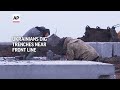 Ukrainians dig trenches near front lines in Kharkiv  - 01:02 min - News - Video