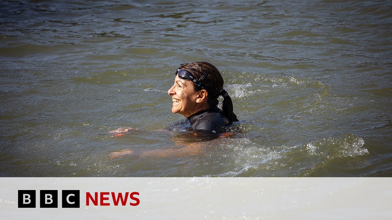 Paris mayor swims in Seine to prove water clean enough for Olympics | BBC News