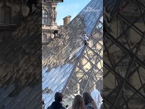 Climate activists scale Louvre pyramid and spray it with orange paint