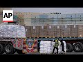 Aid airdrops into Gaza continue as aid trucks cross into the strip