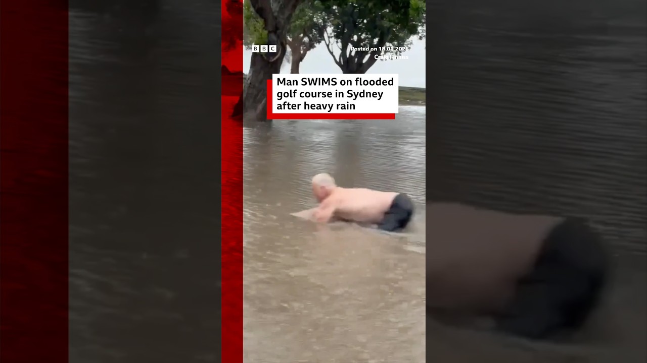 Man swims on flooded golf course in Sydney after heavy rain. Australia BBCNews