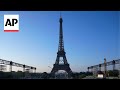 Paris Olympics organizers unveil a display of the five Olympic rings mounted on the Eiffel Tower