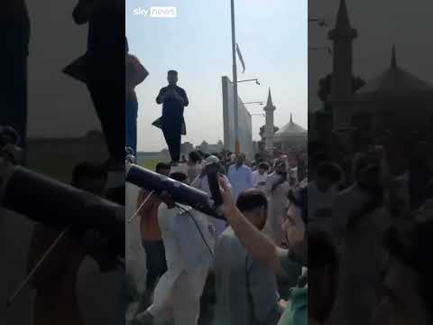 Crowd carries downed drone