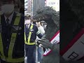 ‘Godzilla’ hits Tokyo streets to promote traffic safety - ABC News