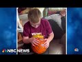 High school varsity basketball team surprises 10-year-old superfan on his birthday
