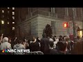Pro-Palestinian demonstrators scream outside Columbia University presidents home