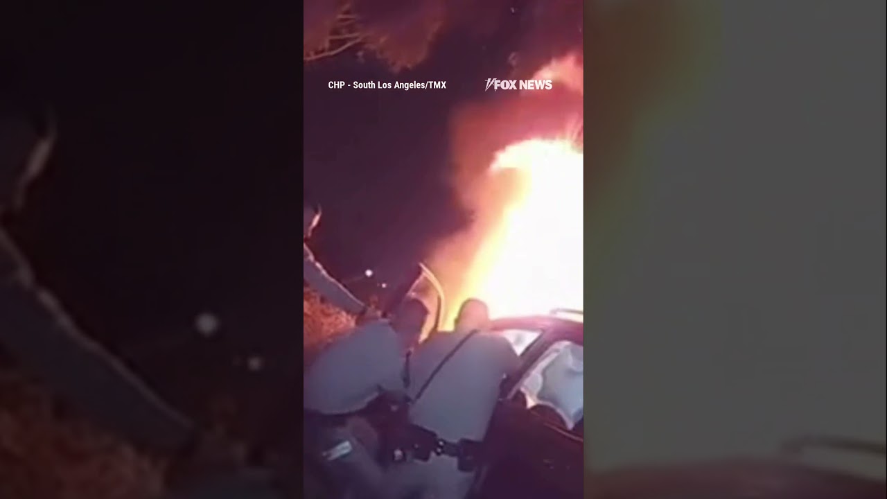 Officers smash windows and pull a trapped driver from a burning car #shorts #viral #news #new #usa
