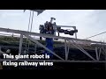 Japans giant robot fixes railway wires