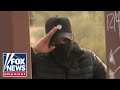 Human smuggler salutes camera at southern border
