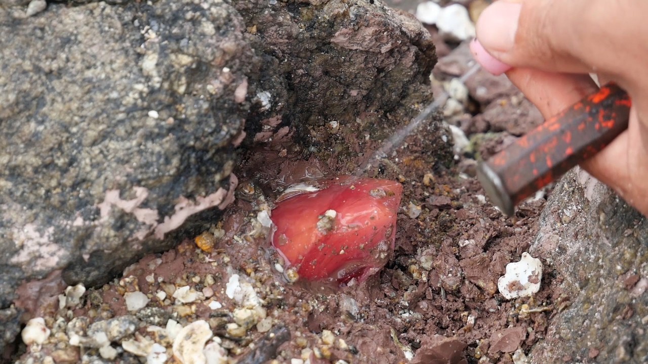 The beautiful woman found many crystals in the abandoned rubble.