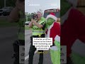 Law enforcement officers dress as Santa and Grinch