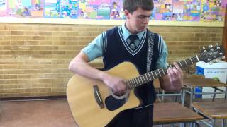 A very talented guitar player showing a trick he mastered
