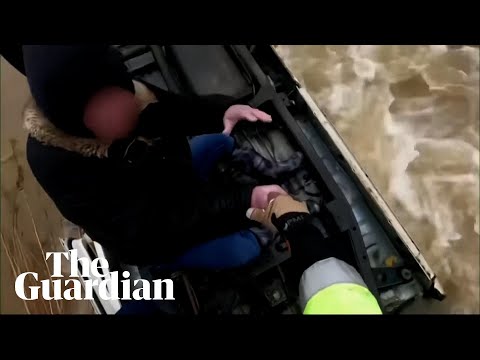 US woman winched to safety after spending 14 hours on top of submerged car